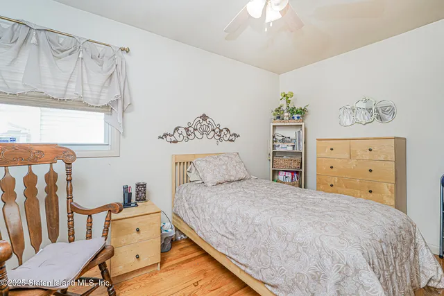 a bedroom with a bed and a dresser in it