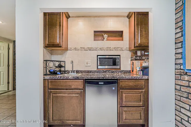 a kitchen with stainless steel appliances granite countertop a stove and a microwave
