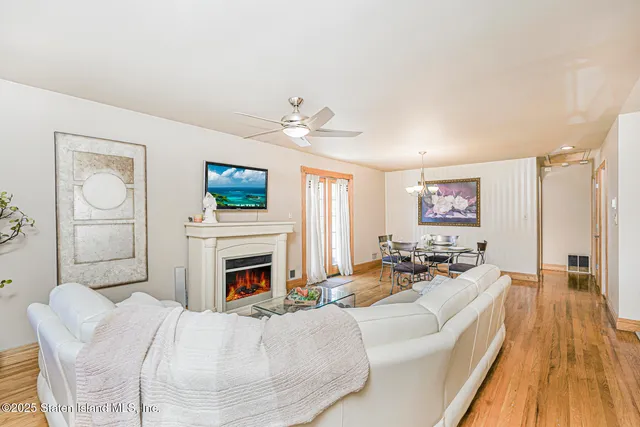 a living room with furniture fireplace and flat screen tv