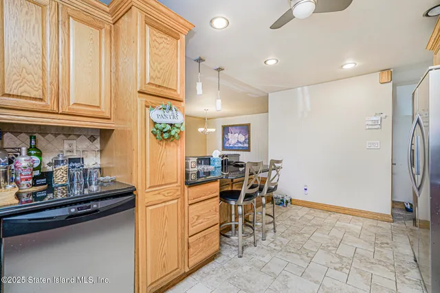 a kitchen with stainless steel appliances granite countertop a refrigerator and a sink