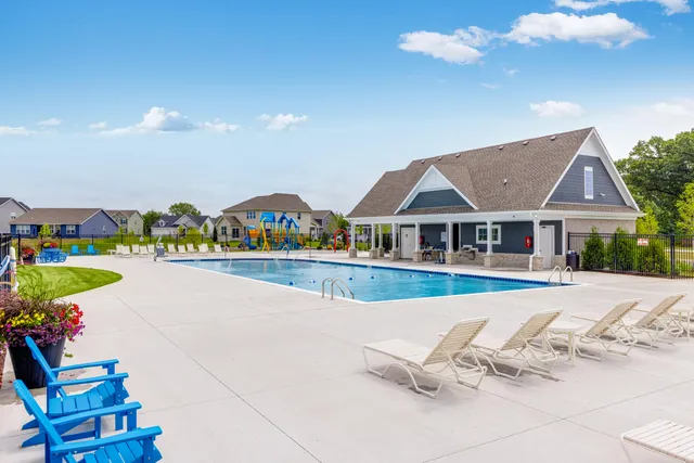 a view of house with outdoor space and swimming pool