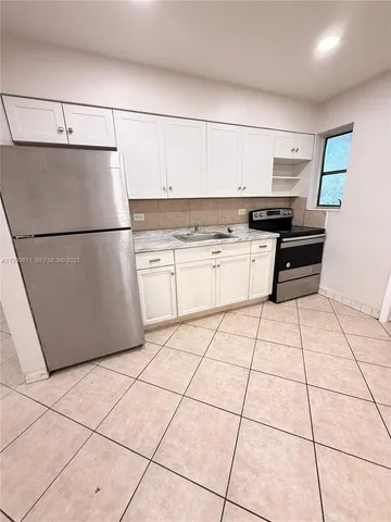 a kitchen with a cabinets and a stove top oven
