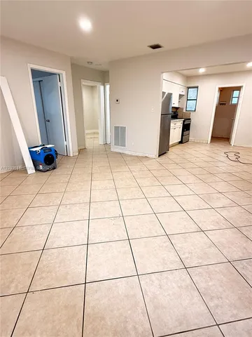 a very nice looking room with a large mirror and tiles