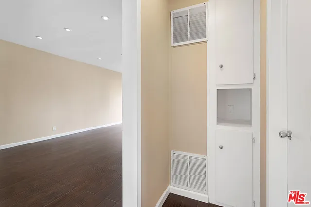 a view of hallway with wooden floor