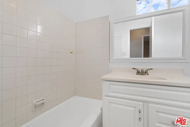 a bathroom with a bathtub and a sink