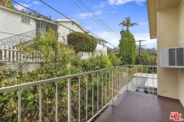 a view of a balcony with chairs