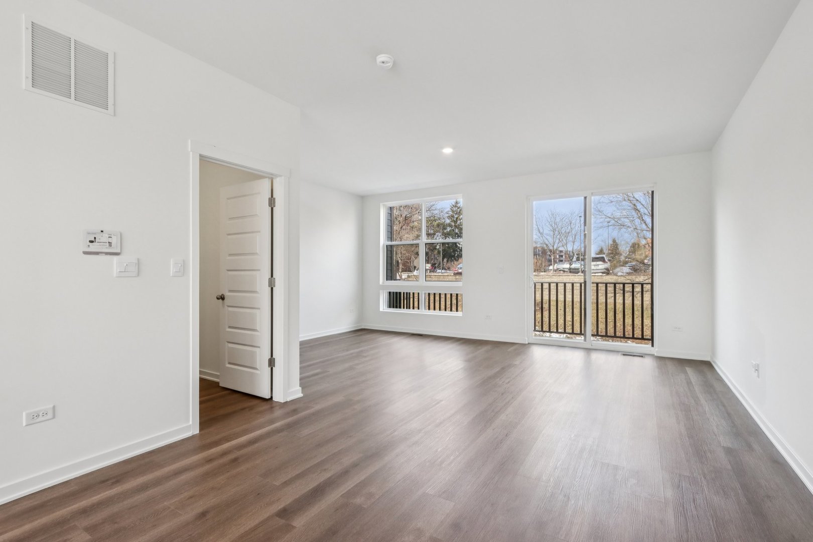 385 Summit Circle Lombard, IL 60148 - Photo 12 of 40 an empty room with wooden floor and windows