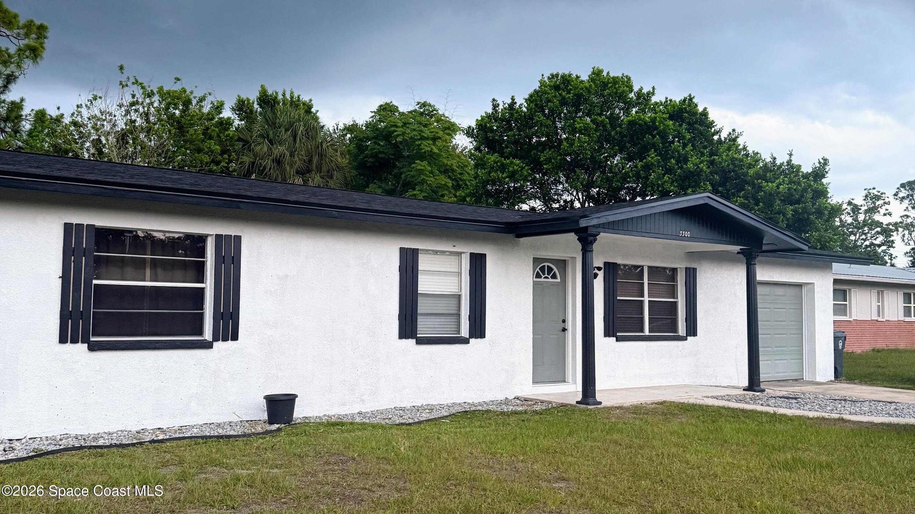 3300 Argyle Road Titusville, FL 32796 - Photo 1 of 29 a front view of a house with a yard