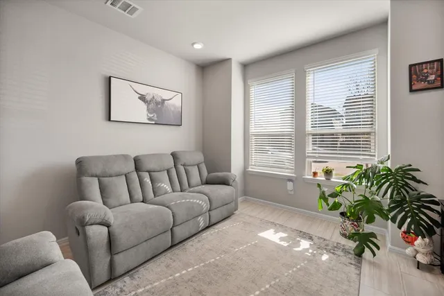a living room with furniture and a potted plant