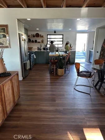 a dining room with furniture and wooden floor
