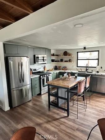 a kitchen with a cabinets and wooden floor