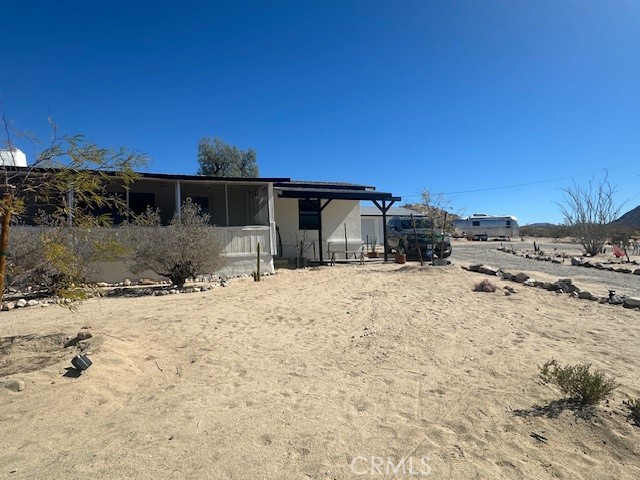 6597 Mesquite Springs Road Twentynine Palms, CA 92277 - Photo 2 of 44 a front view of a house with a yard
