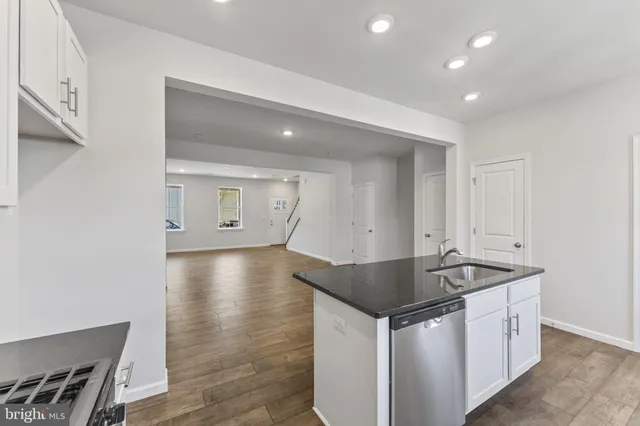 a kitchen that has a sink and a stove in it
