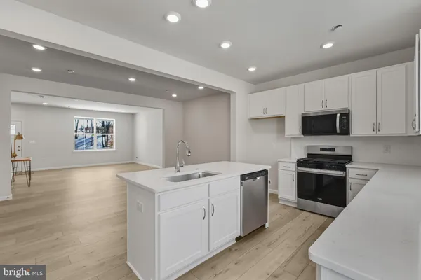 a kitchen with a stove sink and microwave