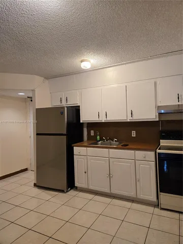 a kitchen with a sink a stove and refrigerator