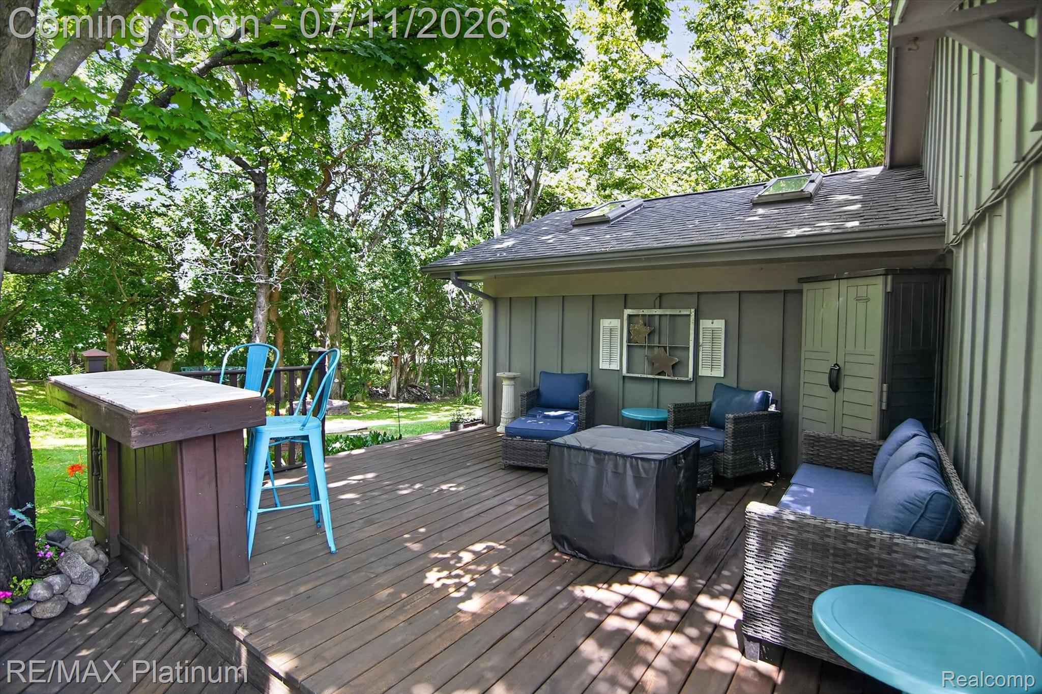 13365 North Territorial Road Gregory, MI 48137 - Photo 42 of 52 Expansive wood-finish deck with a built-in bar, providing direct access to a lush green yard