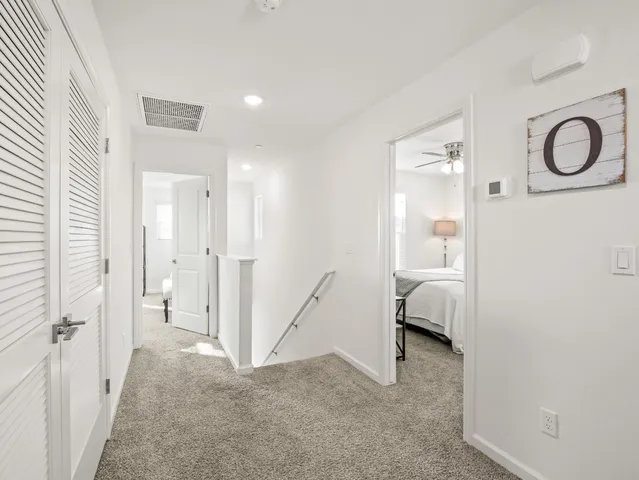 a view of a bedroom with a sink and a mirror
