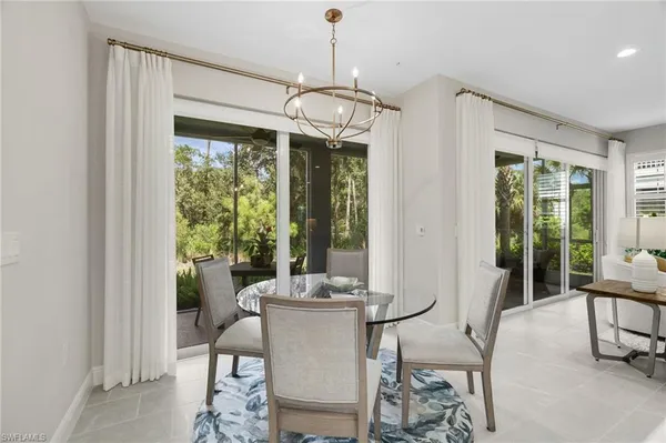 a dining room with furniture window and outside view