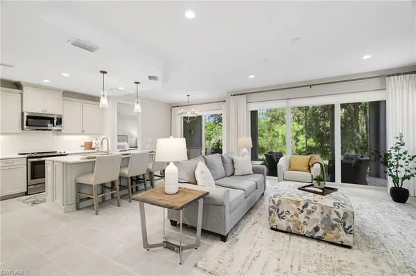 a living room with furniture and a large window