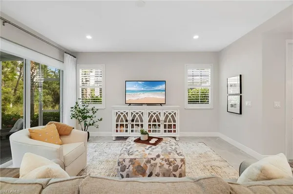 a bedroom with furniture and a large window