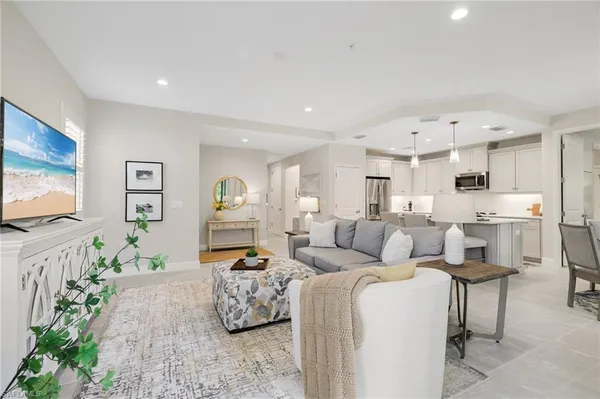 a living room with furniture and a potted plant