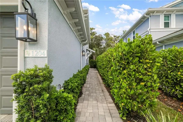 a pathway of a house with a yard