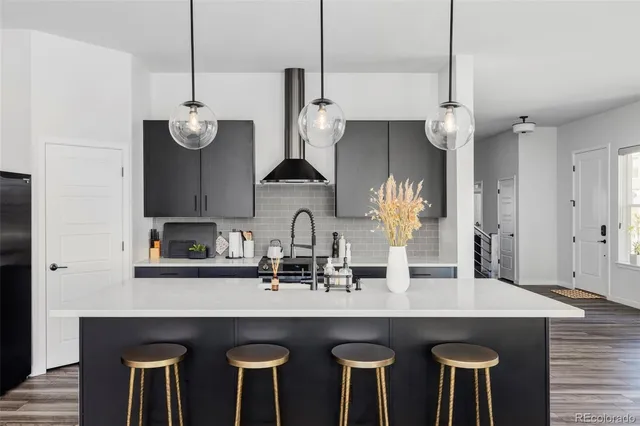 a kitchen with a table chairs and white cabinets