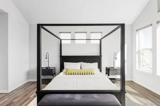 a bed sitting in a bedroom next to a window