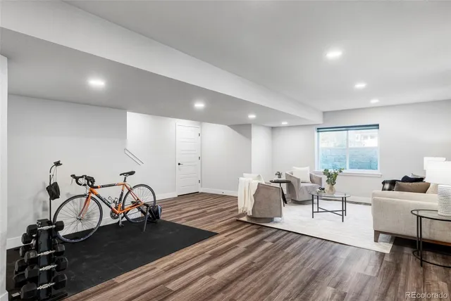 a living room with furniture a table and wooden floor