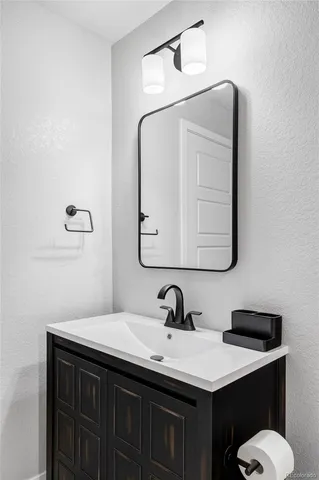 a bathroom with a sink vanity and a mirror