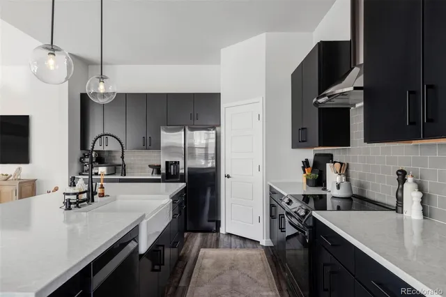 a kitchen with a sink appliances and cabinets