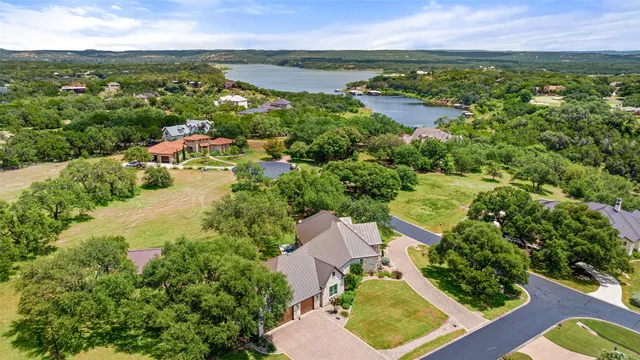 an aerial view of residential houses with outdoor space and ocean view