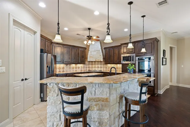 a large kitchen with a table and chairs