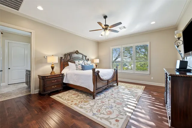 a spacious bedroom with a bed and a chandelier