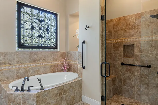 a bathroom with a tub and a shower