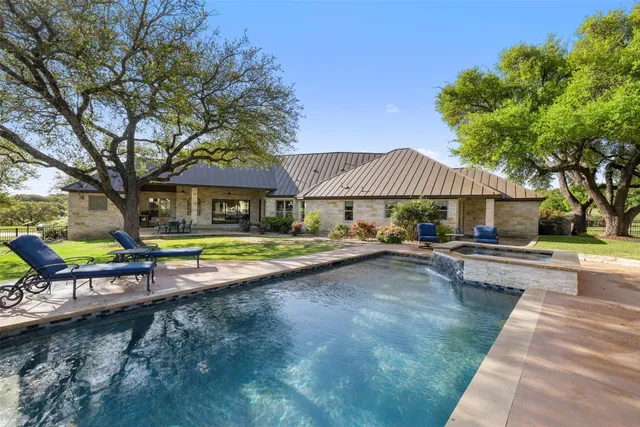 a view of swimming pool with sitting area