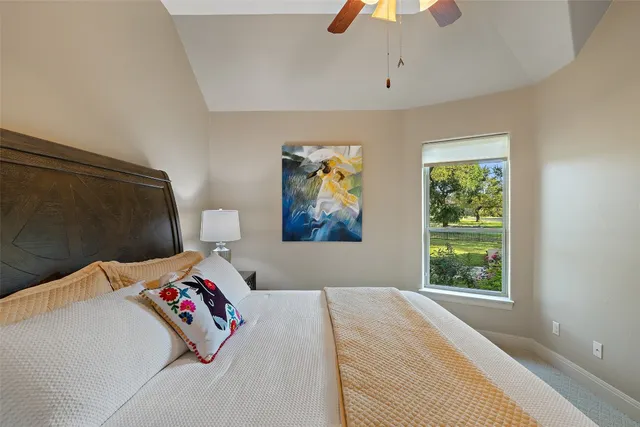 a bedroom with a bed and a painting on the wall