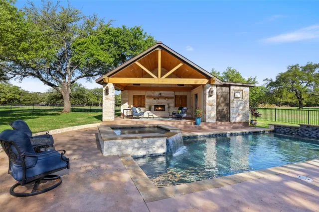 a view of a house with swimming pool and a yard