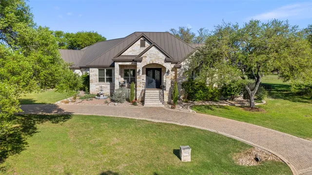a view of a house with a swimming pool and a yard