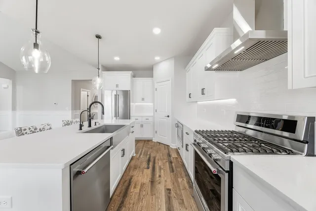 a kitchen with a sink a stove and a refrigerator