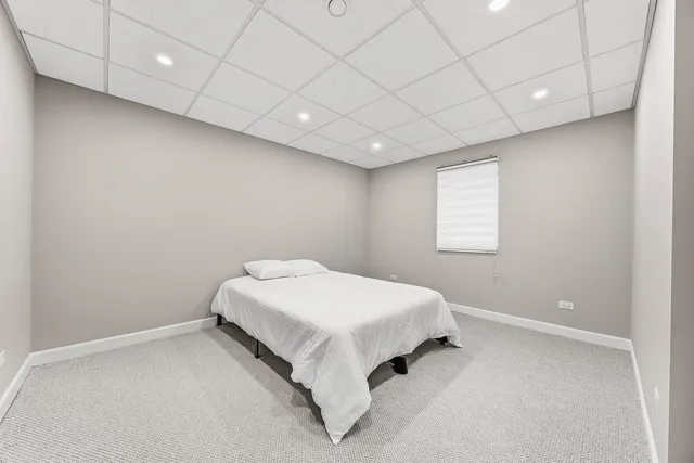 a bed room with a bed and a window