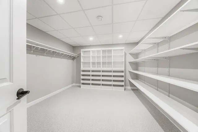 a view of walk in closet with empty racks
