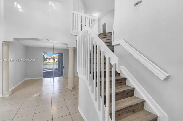 a view of entryway and hall with wooden floor