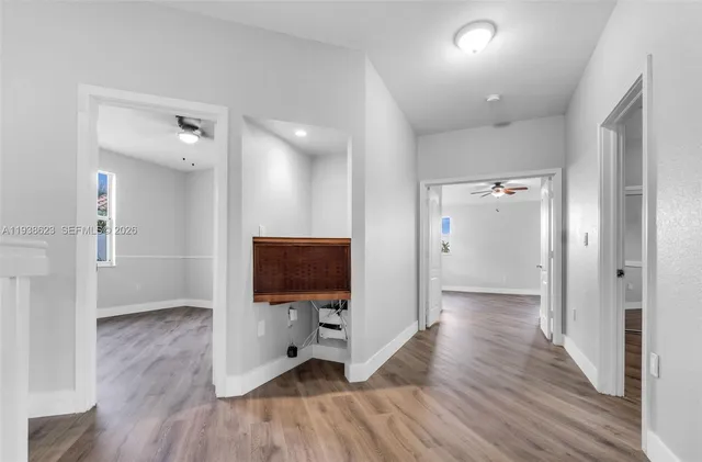 a view of a livingroom with wooden floor and a flat screen tv