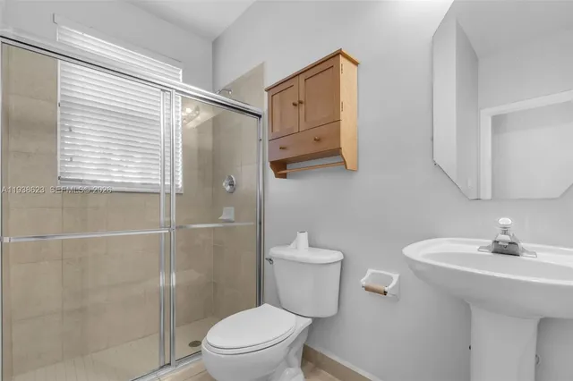 a bathroom with a sink toilet and shower