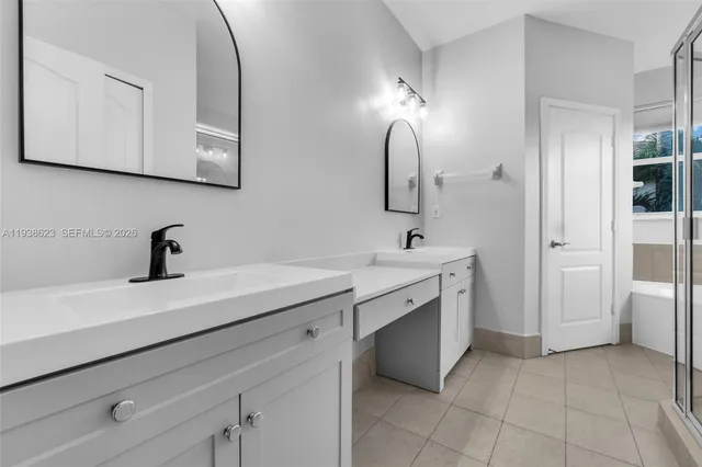 a spacious bathroom with a double vanity sink mirror and