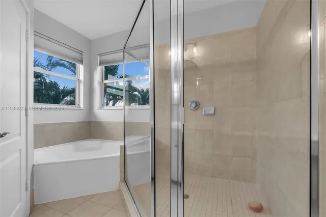 a bathroom with a bathtub and a shower