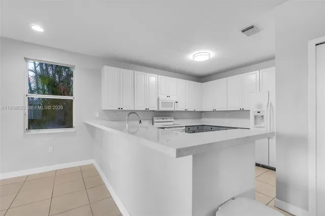 a kitchen with a sink cabinets and window