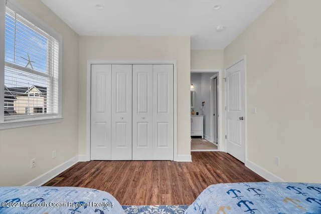 a spacious bedroom with a large bed and a wooden floor