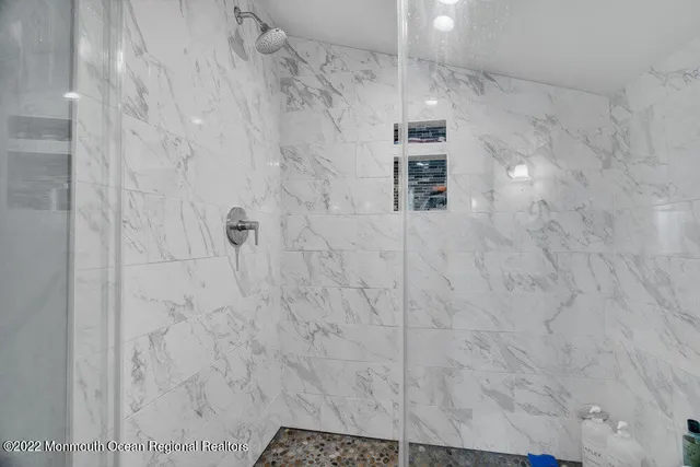 a bathroom with a granite countertop sink a toilet and a bathtub